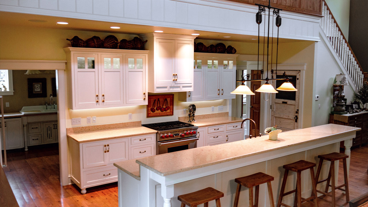 Kitchen with bar, oven, and lighting