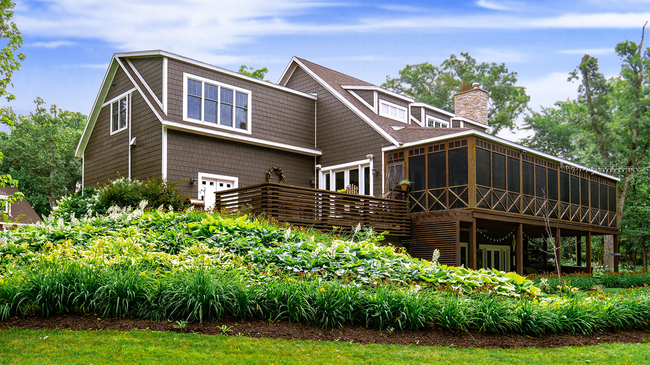 Back of home with garden, deck, and porch